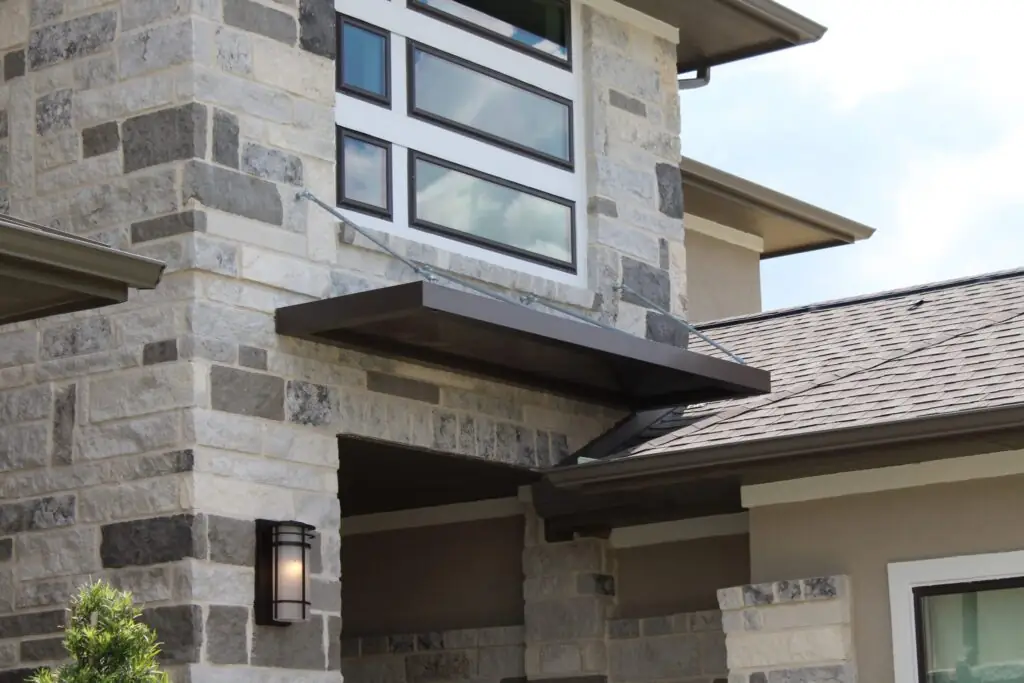 Brown Metallic Products door canopy installed on a residential home
