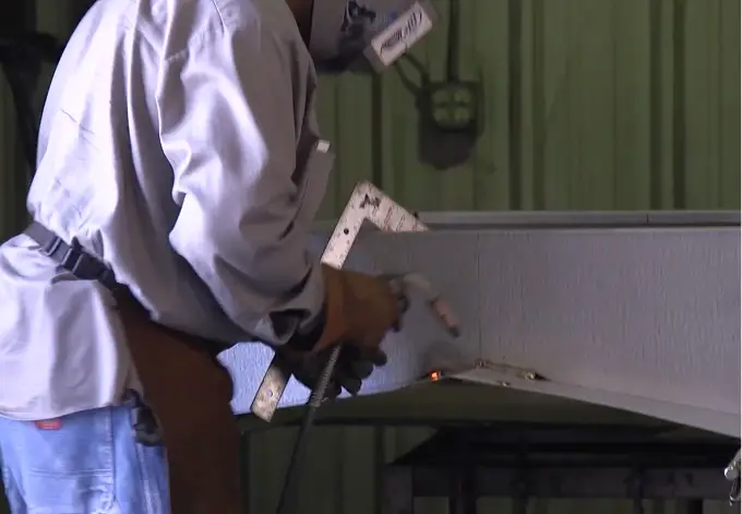 Man building steel building roof curbs