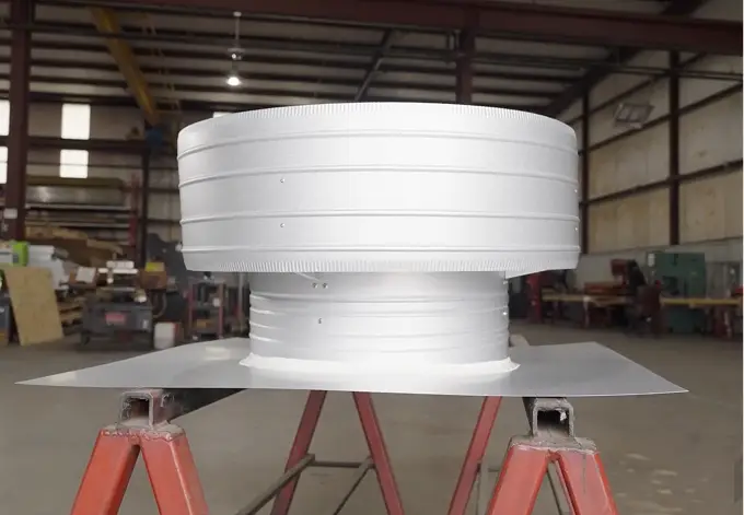 White round gravity vent inside Metallic Products building accessory manufacturing facilitiy